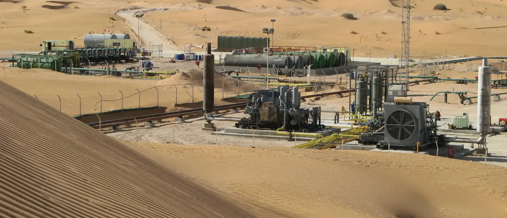 Italfluid production facility among desert dunes